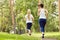 Running sporty mother and daughter. woman and child jogging in park. outdoor sports and fitness family