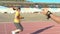 running training in the stadium under the guidance of a coach with a stopwatch, overweight woman runs around the stadium