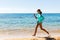 Running woman on the bech. Female runner jogging during outdoor workout on beach