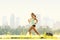 Running woman in city park - outdoor fitness