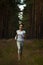 Running woman jogging in in wooded forest area.