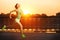 Running woman. Runner is jogging in sunny bright light on sunrise. Female fitness model training outside in the city on a quay.