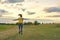 Running young girl with yellow backpack, back with open hands