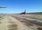 Runway of the airfield. The plane taxiing for take-off on a concrete strip