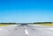 Runway at the airport with good weather and clear blue sky.