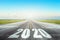 Runway asphalt road with the inscription 2020 year with blue sky. The concept of the beginning of new goals and affairs