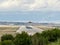 Runway with rubber marks from aircraft landings, while a Boeing 737 aircraft of the Blue bird cargo airline takes off