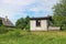 Rural abandoned broken  shed near summer forest