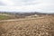 Rural agricultural landscape, tractor ploughing a field