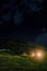 Rural alpine night scene with brightly lit chalet