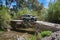 Rural Andalucia. Spain. 06/10/2016. Driving across river in 4x4 on derelict unsecured concrete bridge.