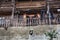 Rural Asian children stand on terrace of Chinese wooden farmhouse