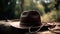 Rural background with close up cowboy hat and rope. Rustic outdoor backdrop with blurred horse. Generative AI