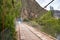 Rural bridge made of wood over river Vilcanota