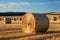 Rural charm Natural landscape featuring a field with hay bale