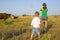 Rural children on a meadow with cows