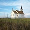 Rural church in field.