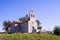 Rural church with a small cemetery on the top of a hill