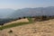 Rural contryside in mountains. Agricultural fields on hills with mountains on background