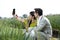 Rural couple using mobile phone in agricultural field