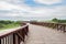 Rural curving planked steel bridge in cloudy summer afternoon