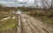 A rural dirt road ends at the river.