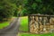 Rural driveway entrance with sandstone wall