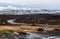 Rural empty road in reykjanes peninsula and snowcapped mountains in Iceland