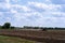 Rural everyday life. Combine rides and plows the field before planting crops. A tractor plows a field. Agriculture, farm and