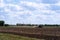 Rural everyday life. Combine rides and plows the field before planting crops. A tractor plows a field. Agriculture, farm and