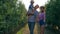 Rural family with cute child have fun in autumn fruit garden during harvest season