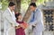 Rural father and daughter receiving piggy bank from businessman