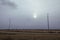 Rural field landscape with lighting pillars along a road