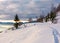 Rural footpath through snowy hillside