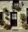 Rural French cottage with hanging baskets, Brittany France