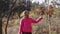 Rural girl enjoys leaf fall in the autumn forest