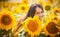 Rural girl in field sunflowers