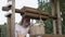 Rural girl looking in wooden bucket on water well in summer village. Young country woman checking water in bucket on