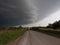 Rural Gravel Road with Gray Clouds Overhead