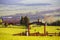 Rural green spring landscape. Fence with arch and Gate