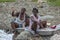 Rural Haitian women wash clothes by hand in the river in northern Haiti.