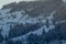 Rural hills, groves and agricultural lands in the winter remote Carpathian mountain village. brae