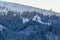 Rural hills, groves and agricultural lands in the winter remote Carpathian mountain village. brae