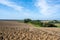 Rural, hilly landscape with freshly ploughed field in autumn. Fresh plowed ararian field 