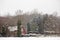 Rural home among woodland in a snowstorm