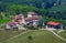 Rural houses among green vineyards and trees.