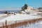 Rural houses and vineyards on snowy hills