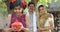 Rural Indian family with surprised daughter holding piggy bank