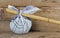 Rural knapsack on a bamboo pole on wooden background