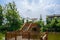 Rural lakeside farmhouses against sunny summer sky